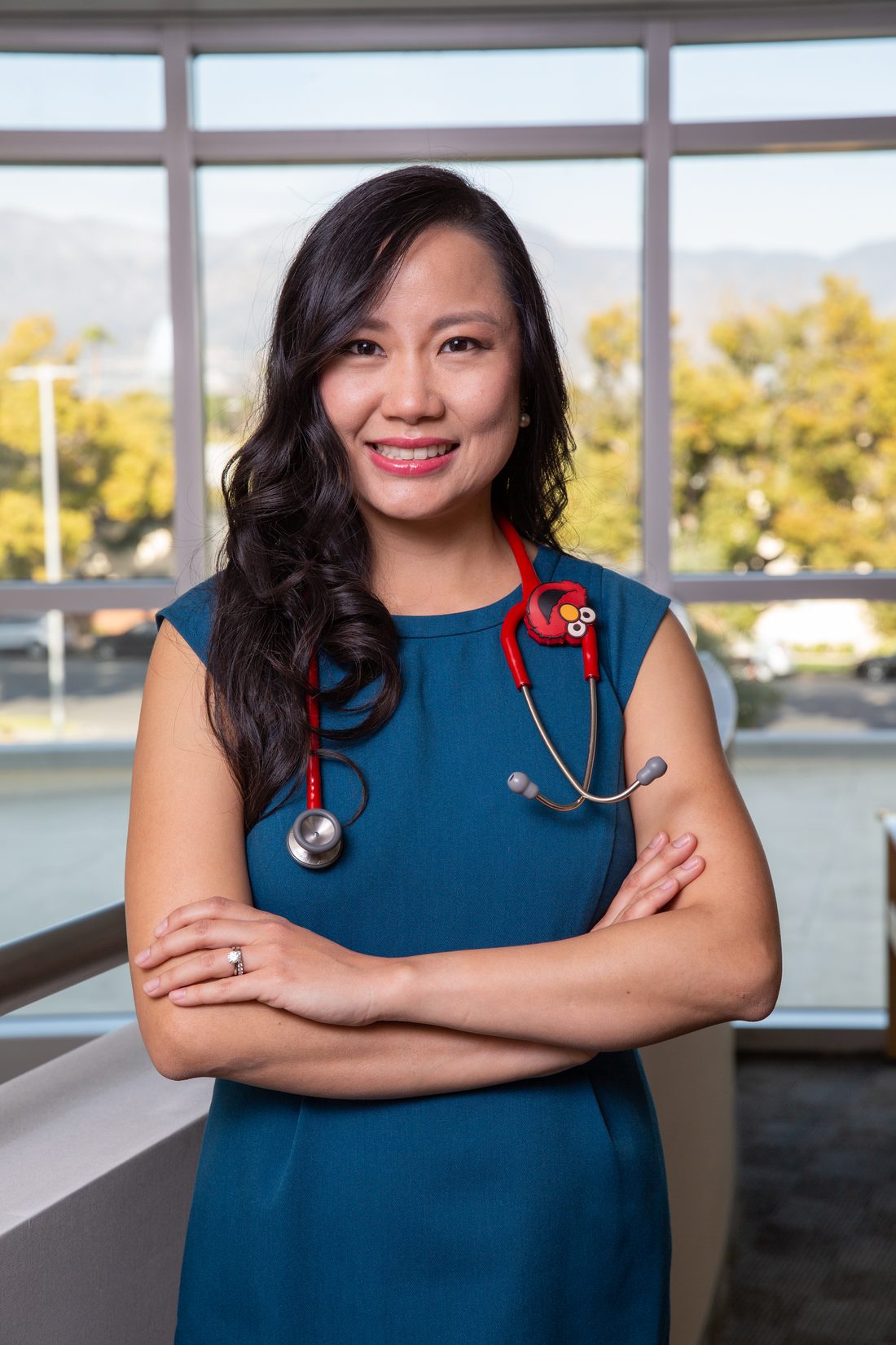 Dr. Rungsima Vayupakparnonde, board-certified pediatrician in Burbank, CA, smiling with her stethoscope